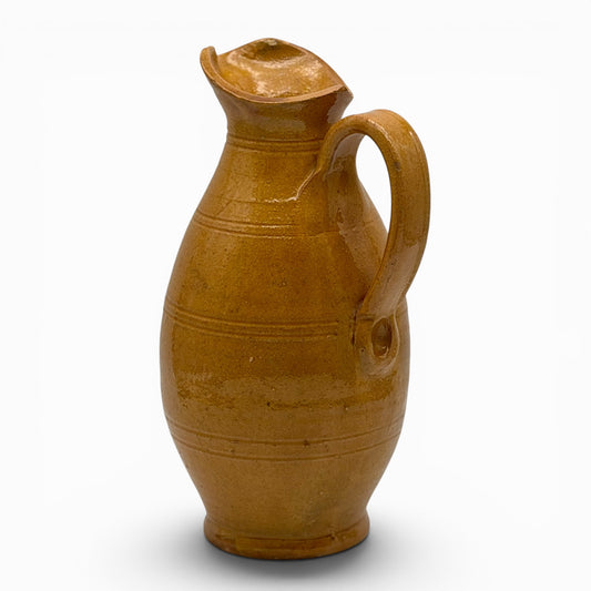 Antique French earthenware tall pitcher with ochre glaze