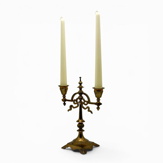 Antique two-arm brass candelabra with serpentine decorations
