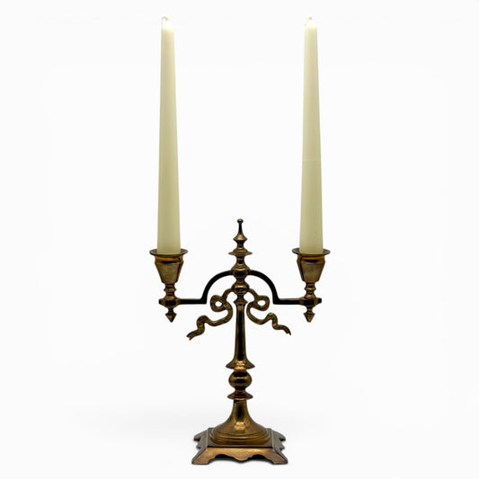 Antique two-arm brass candelabra with serpentine decorations