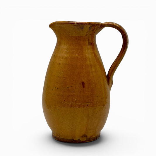 Antique French earthenware round pitcher with ochre glaze