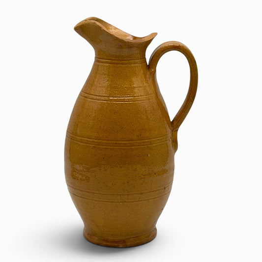 Antique French earthenware tall pitcher with ochre glaze