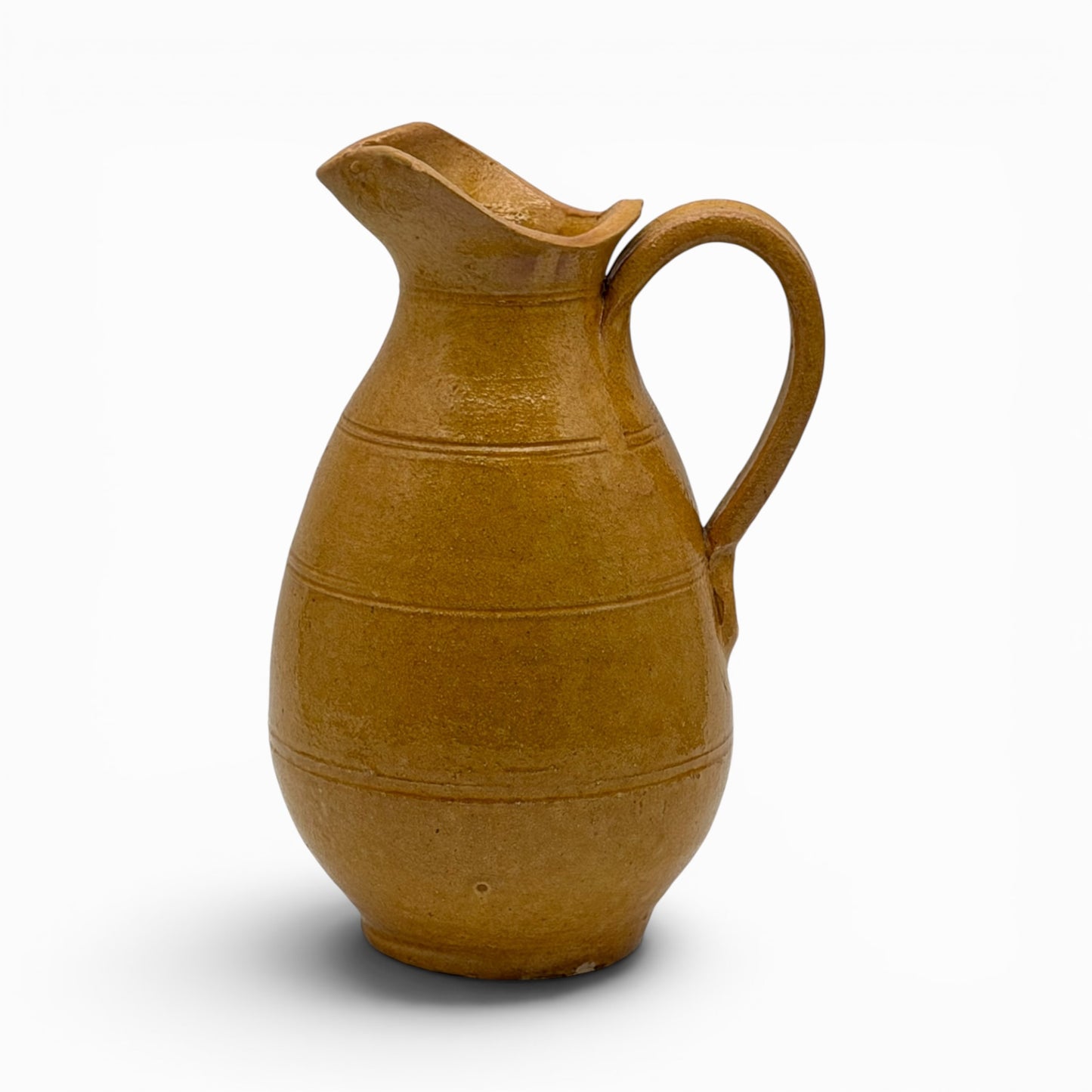 Antique French earthenware medium pitcher with ochre glaze