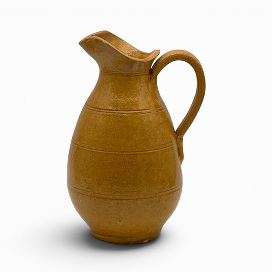 Antique French earthenware medium pitcher with ochre glaze