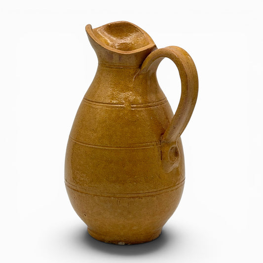 Antique French earthenware medium pitcher with ochre glaze